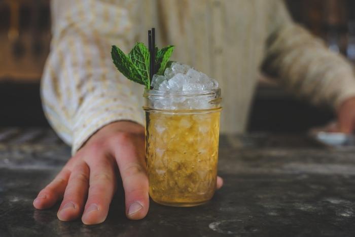mixologist with mint julep for virtual team building ideas to celebrate kentucky derby