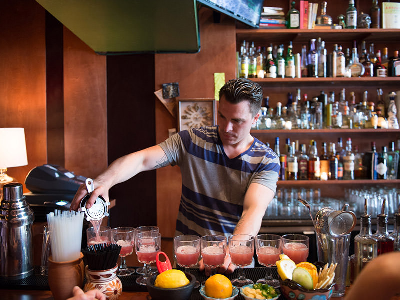 bartender pouring pisco punch cocktails at Cantina in San Francisco