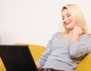 woman laughing during virtual team building games