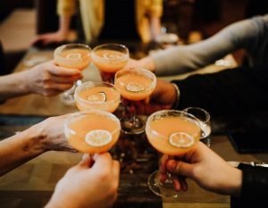 a group cheersing cocktails during birthday party food tours